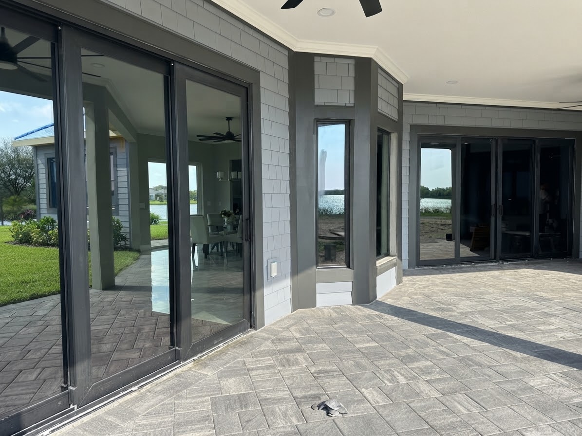 Exterior patio with large sliding glass doors, paver flooring and lake views